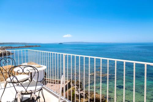 a balcony with a view of the ocean at Relais La Ghinghetta in Portoscuso