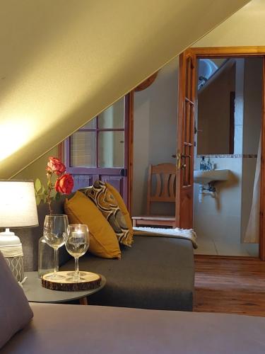 a living room with a couch and a table with wine glasses at Jaun-Ieviņas in Rauna