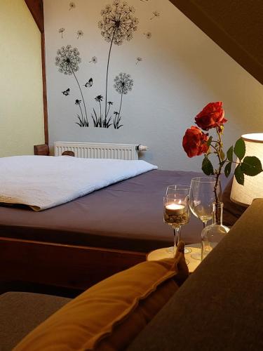 a bedroom with a bed with flowers on the wall at Jaun-Ieviņas in Rauna