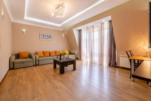a living room with a couch and a table at Spacious apartment in the city center II in Tbilisi City