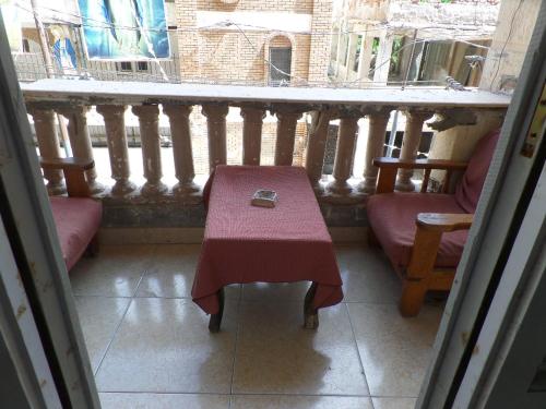 a table and chairs in a room with a window at برج بيلو بيتش in Alexandria