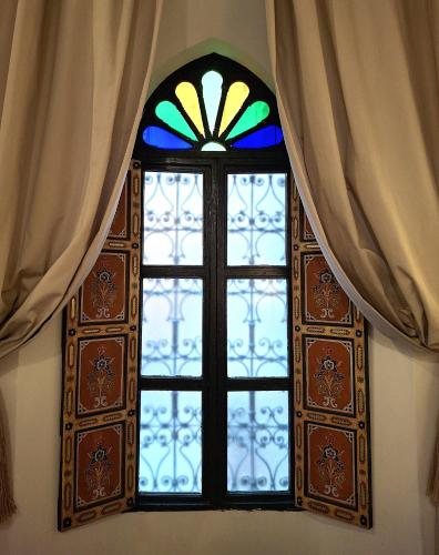 a stained glass window in a room with curtains at Dar El Bali in Fès