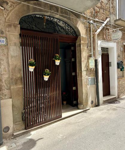 an entrance to a building with two potted plants at THE PALACE B&B and Apartments in Santo Stefano di Camastra