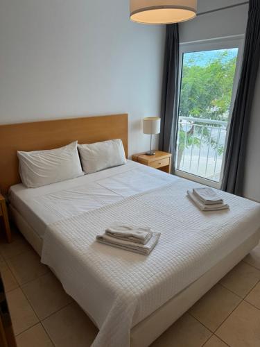 a bedroom with a large bed with towels on it at T1 Apartment Cabanas in Cabanas de Tavira
