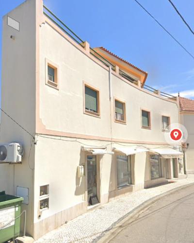 a large white building on the side of a street at Lake View House _ Montargil in Montargil