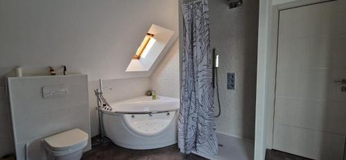 a bathroom with a toilet and a sink and a shower at Fare-Kermenezy maison avec piscine chauffée in Locmaria-Grand-Champ