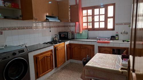 a kitchen with a stove and a washing machine at Dar Salam in Agadir