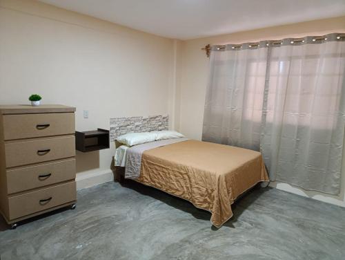 a small bedroom with a bed and a dresser at Atzin 2 in Ixmiquilpan