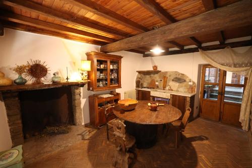 a living room with a table and a fireplace at Casamatta a Blera in Blera