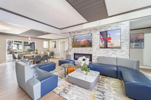a living room with a blue couch and a fireplace at Interurban Suites Hotel in Tukwila