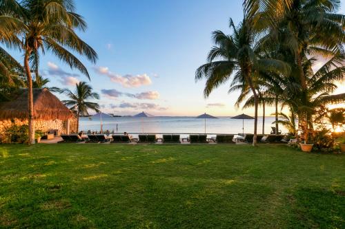 a view of the ocean from the lawn of a resort at Casa Tortugas Boutique Hotel - A Hidden Gem in Cancun in Cancún