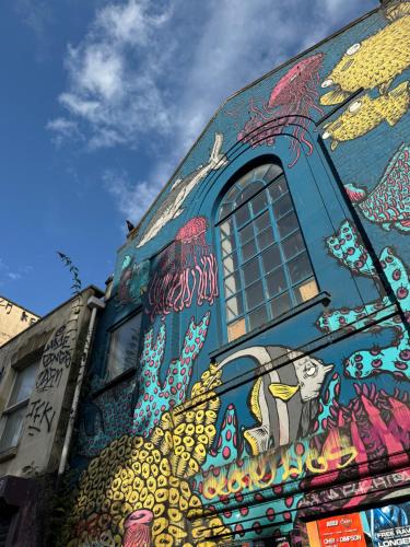 a building with a painting on the side of it at Stokes Croft - Whole Apartment - City Centre - Serviced Accommodation BS1 in Bristol