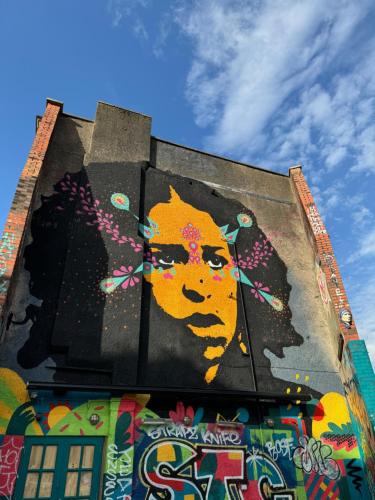 a building with a painting of a woman on it at Stokes Croft - Whole Apartment - City Centre - Serviced Accommodation BS1 in Bristol