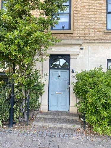 a blue door of a house with a brick building at Upton Country Park Guest House in Northampton