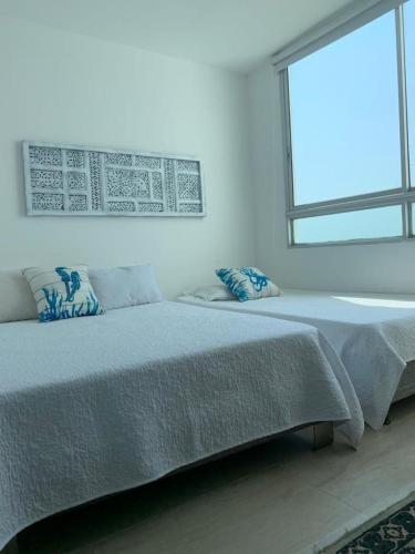 Ένα ή περισσότερα κρεβάτια σε δωμάτιο στο Edificio Mares de Coveñas