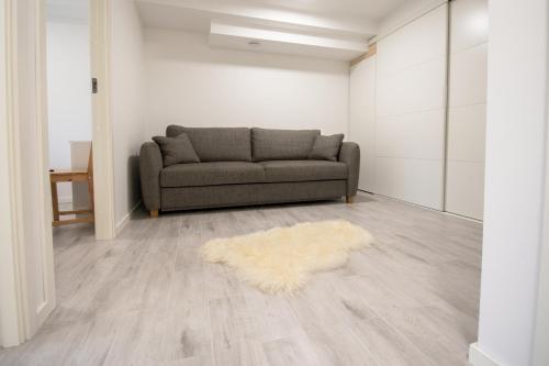 a living room with a couch and a rug at Krok in Värmdö