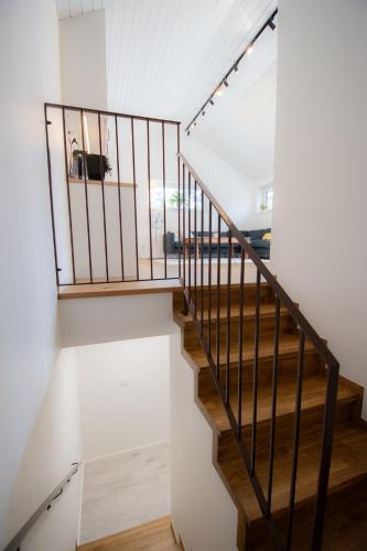 a staircase in a house with white walls and wooden floors at Krok in Värmdö