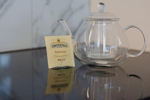 a glass jug with a label on a glass table at Krok in Värmdö