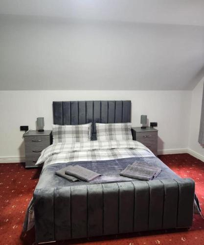 a bedroom with a large bed with two night stands at Rainsough Cottage Guest House - Shared Bathroom - Free Parking & WiFi in Manchester
