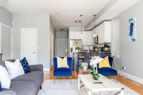 a living room with a gray couch and blue chairs at Fully furnished bedroom near medical district and UIC in Chicago