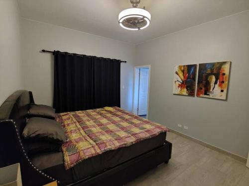 a bedroom with a bed with a blanket on it at Entire Property with Patio in Yona