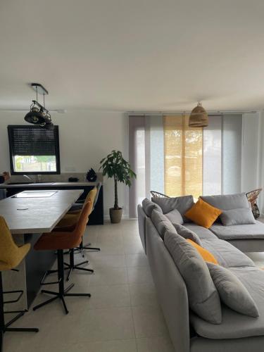 a living room with a couch and a table at Ti Nolgann in Lannilis