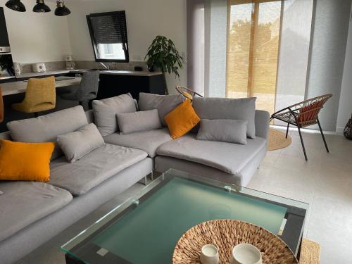 a living room with a couch and a table at Ti Nolgann in Lannilis