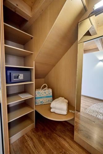 a small room with a bunk bed and a closet at Parc Hotel Flora S in Riva del Garda