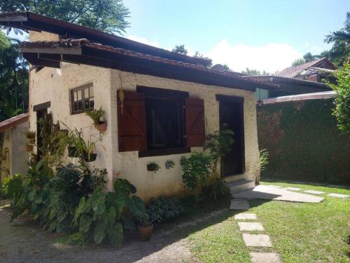 a small house with plants in front of it at Loft situado a 700 metros da praia de Boiçucanga in Boicucanga