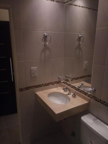 a bathroom with a sink and a mirror at Edificio San Lorenzo in Corrientes