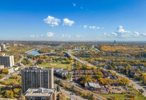 an aerial view of a city with trees and buildings at Downtown Near Rogers Place with Covered Parking, Sleeps 6, Pool Table, Sauna, Gym, Two Bedrooms & More in Edmonton