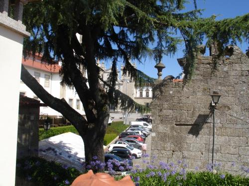 a row of cars parked in a parking lot next to a wall at ChezGyKa - Sinta-se Em Casa! in Viseu
