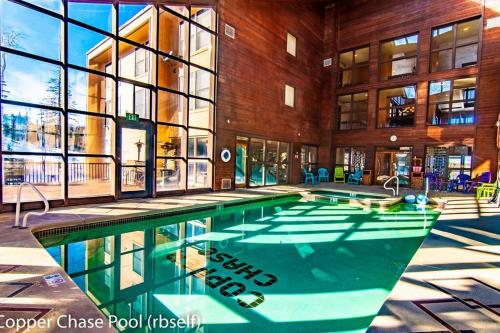 a swimming pool in the middle of a building at Royal Queen Suite Pool-Spa Ski-in out Gym, Sauna, Laundry, BBQ in Brian Head