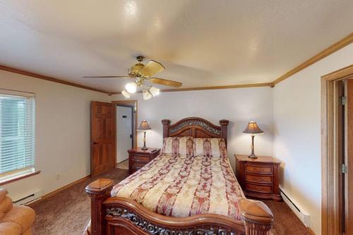 a bedroom with a bed and a ceiling fan at Royal Queen Suite Pool-Spa Ski-in out Gym, Sauna, Laundry, BBQ in Brian Head