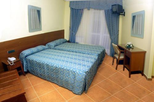 Postel nebo postele na pokoji v ubytování Hostal Castilla