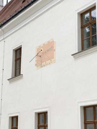 a clock on the side of a white building at Schloss Thalheim in Sankt Pölten