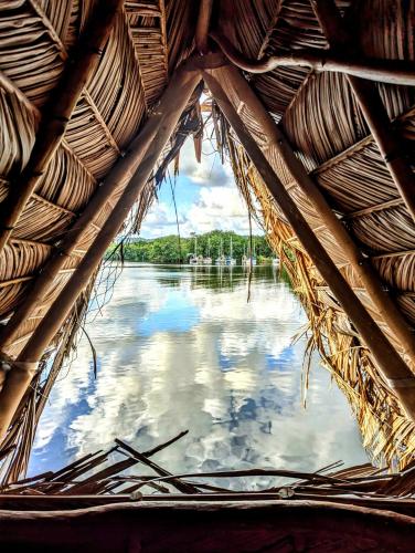 a view of the water from a straw hut at La Isla Dulce in Lívingston