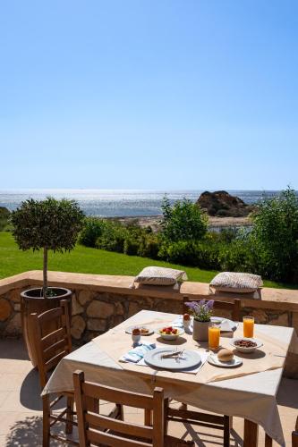 a table with food and drinks on a patio at Al Mare Villas in Kiotari
