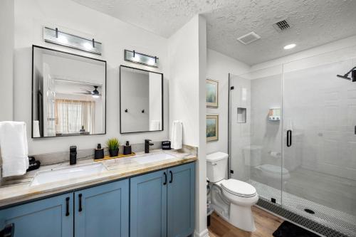 a bathroom with a sink and a toilet and a shower at Walkable Montrose 2BR Houston Mural Sleeps 9 in Houston