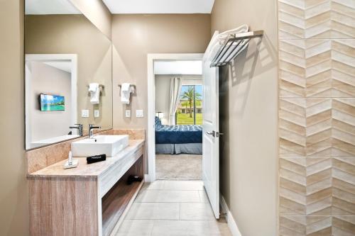 a bathroom with a sink and a mirror at MAGIC VILLAGE - Near Disney - 4BDR in Orlando