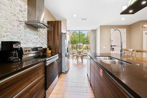 a kitchen with a sink and a counter top at MAGIC VILLAGE - Near Disney - 4BDR in Orlando
