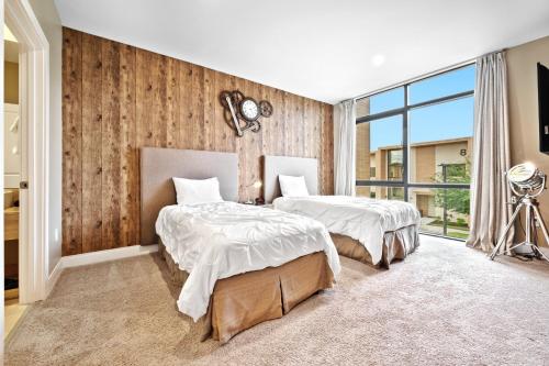 a bedroom with two beds and a large window at MAGIC VILLAGE - Near Disney - 4BDR in Orlando