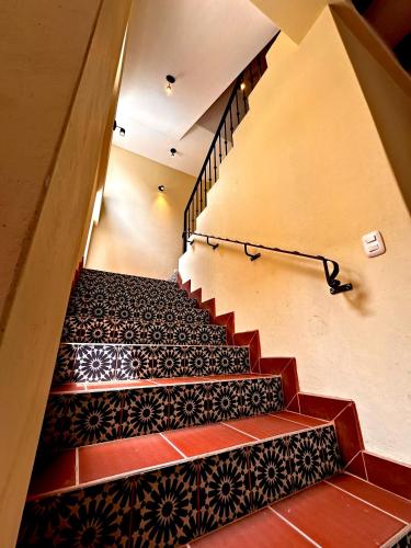 a set of stairs with black and red tile at Hotel Jotam in Panajachel