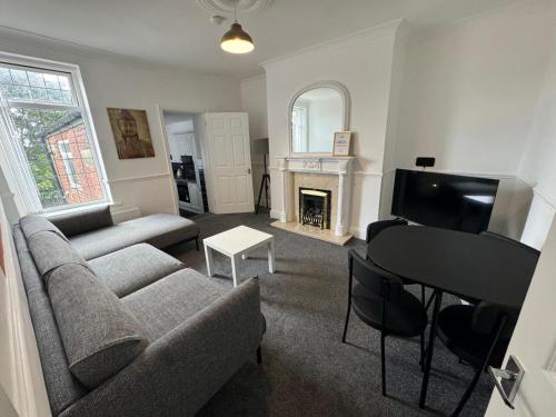 a living room with a couch and a piano at Luna Apartments Newcastle Gateshead 1 in Gateshead