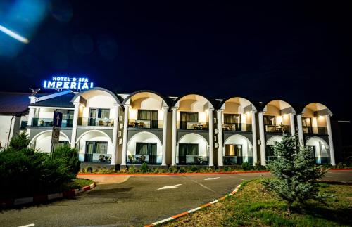 a large white building with a sign on it at Hanul Domnesc Imperial Hotel & SPA in Călan