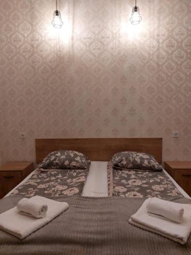 a bedroom with a bed with two towels on it at Eco Oasis in Surami