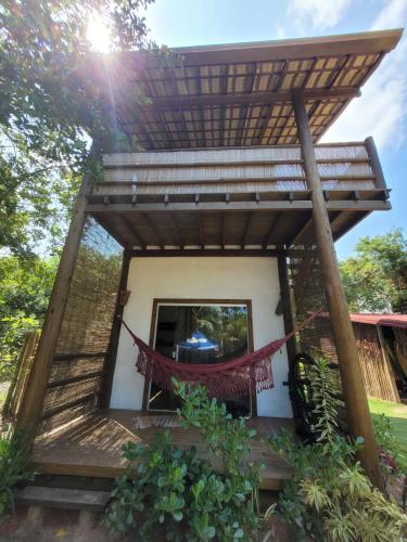 a small house with a thatched roof at Bahia Soul - Kawai Suítes - Taipu de Fora - Península de Maraú in Marau
