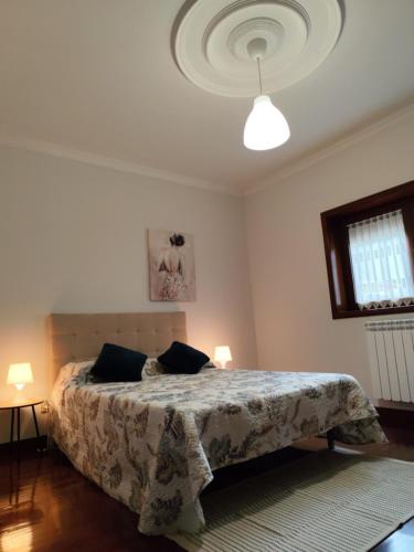 a bedroom with a bed with two pillows on it at Casa Mercedes in Cabeceiras de Basto
