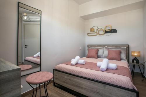 a bedroom with a large bed and a mirror at Kiki Luxury Villa in Afantou
