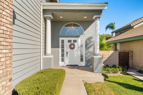 a house with a white door with a wreath on it at Near Airport & Outlet & ONT Field 6 bedroom large house in Ontario